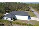 Aerial view of a home showcasing its clean white exterior and newly installed roof at 435 Mcdill Dr, Port Charlotte, FL 33953