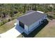 A high angle view of a single story home with a black roof and a long driveway at 435 Mcdill Dr, Port Charlotte, FL 33953