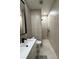 Modern bathroom featuring sleek black hardware, tiled walls, and a frameless glass shower enclosure at 435 Mcdill Dr, Port Charlotte, FL 33953