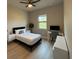 Bright bedroom with a ceiling fan, bedside table, a view from the window and a dedicated workspace at 435 Mcdill Dr, Port Charlotte, FL 33953