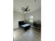 Relaxing bedroom space featuring a ceiling fan, comfortable bed, and practical desk area at 435 Mcdill Dr, Port Charlotte, FL 33953
