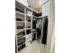 Well-organized walk-in closet with custom shelving and ample storage space for clothes and accessories at 435 Mcdill Dr, Port Charlotte, FL 33953