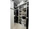 Spacious walk-in closet with built-in shelves and hanging rods, providing plenty of storage solutions at 435 Mcdill Dr, Port Charlotte, FL 33953