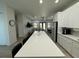 Open-concept kitchen with white cabinetry, large island, and view into the living area at 435 Mcdill Dr, Port Charlotte, FL 33953