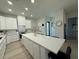 Clean kitchen featuring white cabinets, stone countertops, and a central island at 435 Mcdill Dr, Port Charlotte, FL 33953