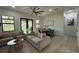 Open-concept living room with hardwood floors, modern lighting, and access to the outdoors at 435 Mcdill Dr, Port Charlotte, FL 33953