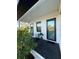 Cozy, covered patio featuring sleek black deck flooring and space for outdoor seating at 435 Mcdill Dr, Port Charlotte, FL 33953