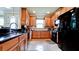 Kitchen featuring granite countertops, stainless steel appliances, wood cabinets, and tile flooring at 5352 Vaccaro Ct, Bradenton, FL 34211