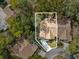 Aerial view of the home, showcasing the surrounding neighborhood and lush trees at 6785 Poinciana Ct, Spring Hill, FL 34606