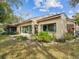 Exterior shot of the back of the home showcasing the yard and well-maintained landscaping at 6785 Poinciana Ct, Spring Hill, FL 34606