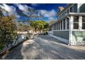 Paver driveway leading up to a two-story home, showcasing its landscaped yard at 304 15Th W St, Bradenton, FL 34205