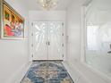Bright and spacious entryway with palm tree etched doors at 443 Picasso Dr, Nokomis, FL 34275