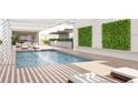 Relaxing rooftop pool with lounge chairs and lush greenery at 1305 4Th St # 401G, Sarasota, FL 34236