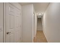 Bright hallway with tile flooring leads to carpeted stairs, illuminated by a modern light fixture at 8922 White Sage Loop # 3001, Lakewood Ranch, FL 34202