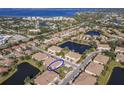 Aerial view of a townhouse community with water features, showing the subject property at 7317 Skybird Rd # 7317, Bradenton, FL 34209