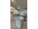 Spacious kitchen featuring a large island and white cabinetry at 2665 Ensenada Ln, North Port, FL 34286