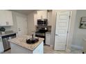 Modern kitchen with stainless steel appliances and granite countertops at 2665 Ensenada Ln, North Port, FL 34286