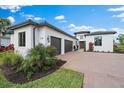 Three-car garage and paver driveway, modern white house at 3739 Caledonia Ln, Sarasota, FL 34240