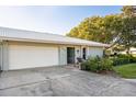 White garage door and entryway with patio furniture at 6505 10Th W Ave # 5618, Bradenton, FL 34209