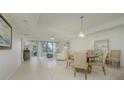 Open concept dining area with neutral tones and natural light at 1660 Summerhouse Ln # 102, Sarasota, FL 34242