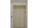 Modern elevator with neutral-colored walls and doors at 1660 Summerhouse Ln # 102, Sarasota, FL 34242