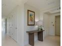 Bright hallway with tile floors and simple decor at 1660 Summerhouse Ln # 102, Sarasota, FL 34242