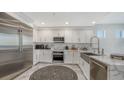 Modern kitchen with stainless steel appliances and white cabinets at 611 Riviera Dunes Way # 702, Palmetto, FL 34221