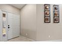 Inviting entryway with neutral walls and a white door at 4211 Fairway Pl, North Port, FL 34287