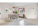 Bright dining area with modern table and chairs, staged for appeal at 1654 Waxwing Ct, Venice, FL 34293