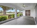 Bright screened porch with tile floors and scenic backyard views at 1654 Waxwing Ct, Venice, FL 34293