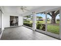 Spacious screened porch with tiled floors and view of the backyard at 1654 Waxwing Ct, Venice, FL 34293