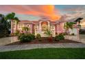 Grand two-story home with Mediterranean styling and landscaped grounds at 4409 Crews Ct, Port Charlotte, FL 33952