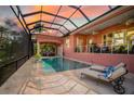 Inviting pool and spa area with covered lanai and lounge chairs at 4409 Crews Ct, Port Charlotte, FL 33952