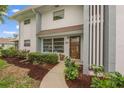 Condo entrance with manicured landscaping and walkway at 542 Sutton Pl, Longboat Key, FL 34228