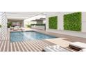 Relaxing rooftop pool with a pergola and lush greenery at 1305 4Th St # 103C, Sarasota, FL 34236