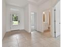 Elegant foyer with tile floors and access to a half bathroom at 19642 Fort King Run, Brooksville, FL 34601