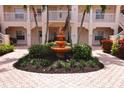 Attractive courtyard with fountain and tropical landscaping at 4264 Central Sarasota Pkwy # 116, Sarasota, FL 34238