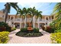 Two-story building with balconies, lush landscaping, and a central fountain at 4264 Central Sarasota Pkwy # 116, Sarasota, FL 34238