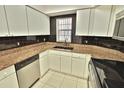 Galley-style kitchen with granite countertops and stainless steel appliances at 4264 Central Sarasota Pkwy # 116, Sarasota, FL 34238