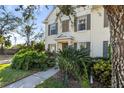 Charming two-story home featuring manicured landscaping, a welcoming walkway, and shuttered windows at 5654 Simonton St, Bradenton, FL 34203