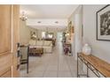 Bright and airy living room with tiled floors, neutral decor and views to dining area at 2383 Harbour Oaks Dr, Longboat Key, FL 34228