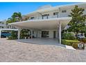 Modern building exterior with covered entryway and landscaping at 100 Sands Point Rd # 305, Longboat Key, FL 34228