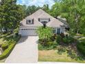 An inviting single-Gathering home shows off mature landscaping, a paver driveway, and a well-maintained lawn at 7249 Orchid Island Pl, Bradenton, FL 34202