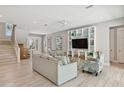 Bright living room with light wood floors, comfortable seating, and built-in shelving at 149 Mckinley Dr, Sarasota, FL 34236