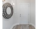 Bright entryway with a large circular mirror and white door at 3702 54Th W Dr # 102, Bradenton, FL 34210