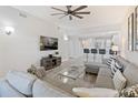 Open living room with gray sectional sofa and kitchen view at 3702 54Th W Dr # 102, Bradenton, FL 34210