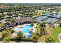 Community pool with tennis courts and clubhouse aerial view at 6918 Grand Estuary Trl # 102, Bradenton, FL 34212