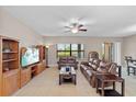Living room featuring leather sofas, wood furniture, and a large TV at 6309 75Th E Ave, Palmetto, FL 34221
