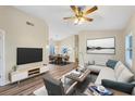 Bright living room with modern decor, wood floors, and a comfortable seating area at 318 Chartley N Ct, Sarasota, FL 34232
