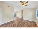 Spacious living room with wood floors, neutral walls, and plenty of natural light at 318 Chartley N Ct, Sarasota, FL 34232